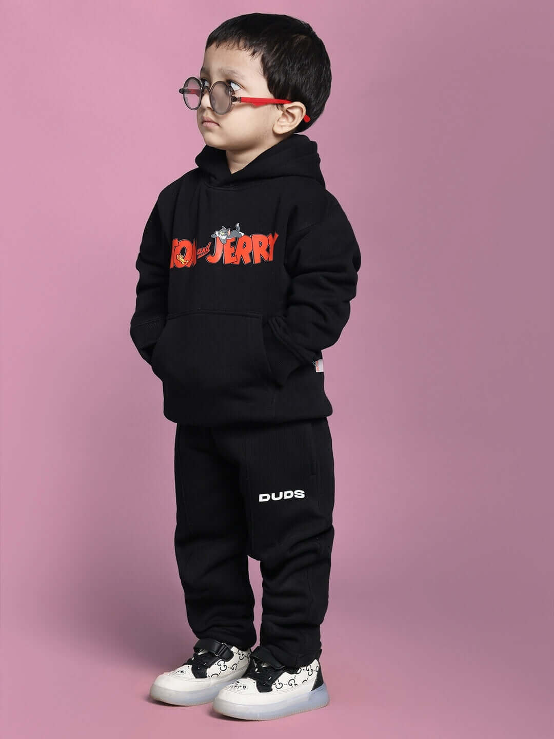 Child wearing black Tom & Jerry co-ord outfit; hoodie and pants set for boys and girls.