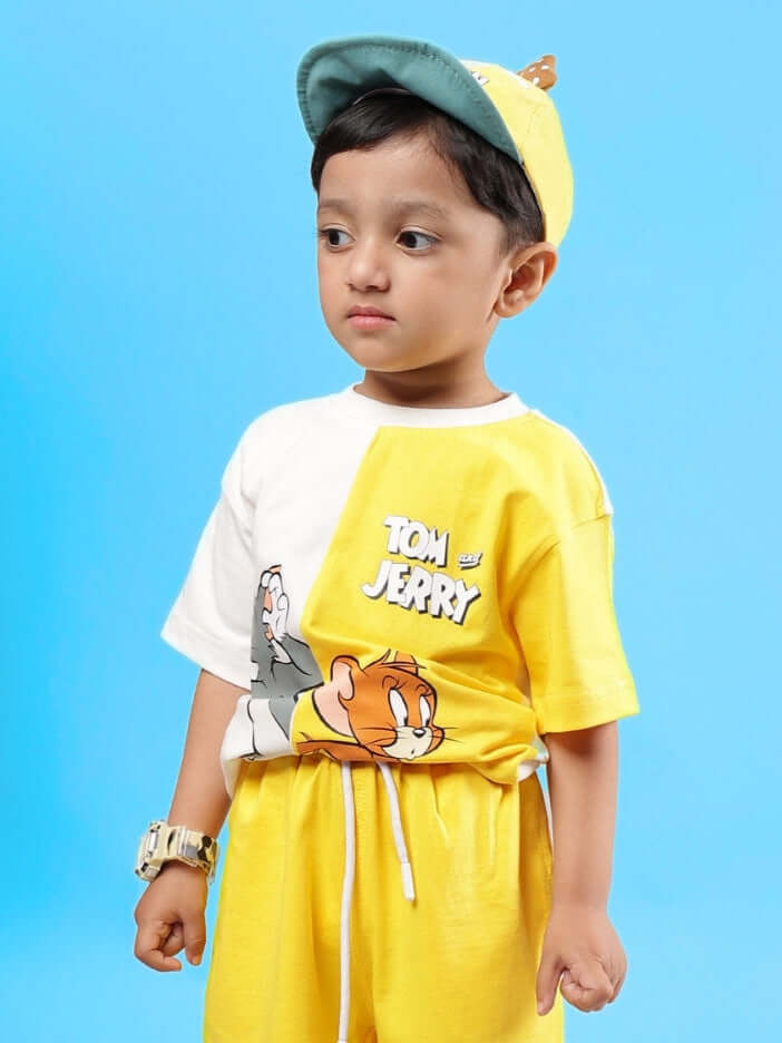 Child wearing an oversized off white-yellow Tom & Jerry t-shirt, showcasing playful design, suitable for boys and girls.