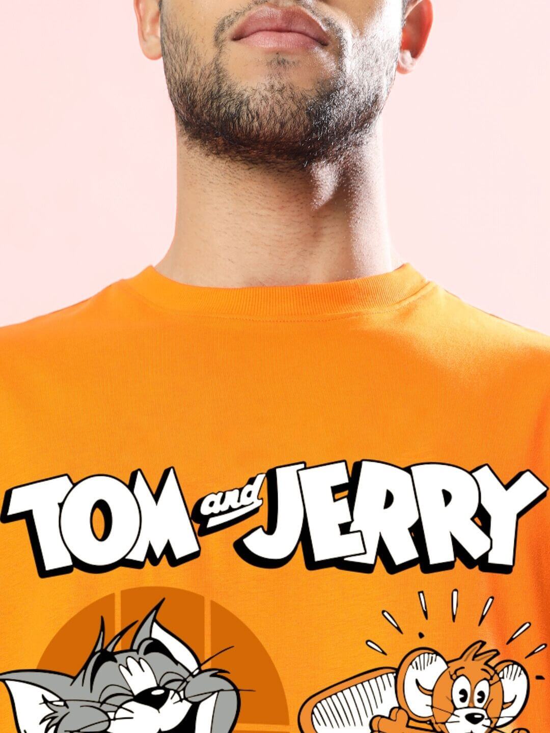 Close-up of Tom and Jerry Toast graphic on TOM AND JERRY TOAST OVERSIZED T-SHIRT ORANGE with iconic characters, emphasizing retro charm.
