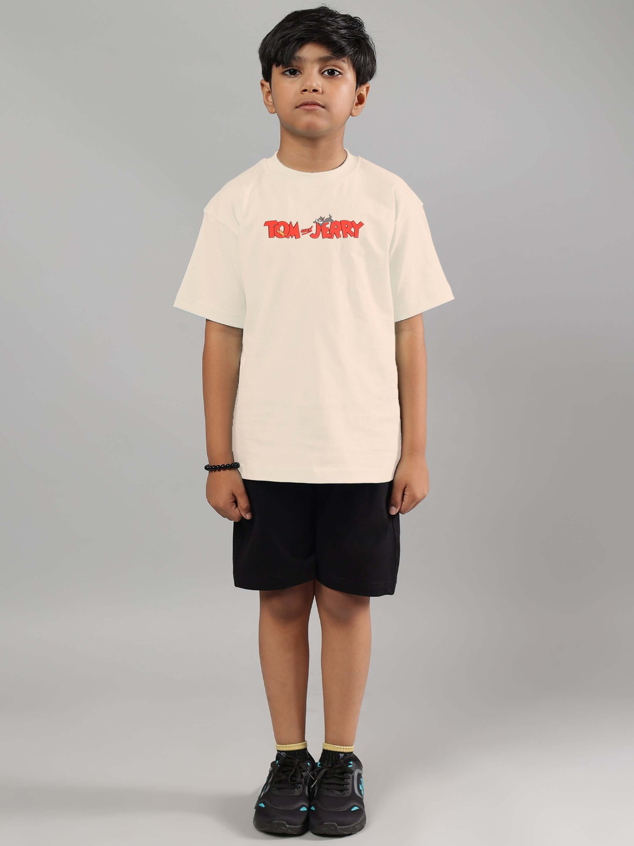 Tom & Jerry off-white t-shirt for boys and girls, modeled by a child, showcasing casual style and comfort suitable for all kids.