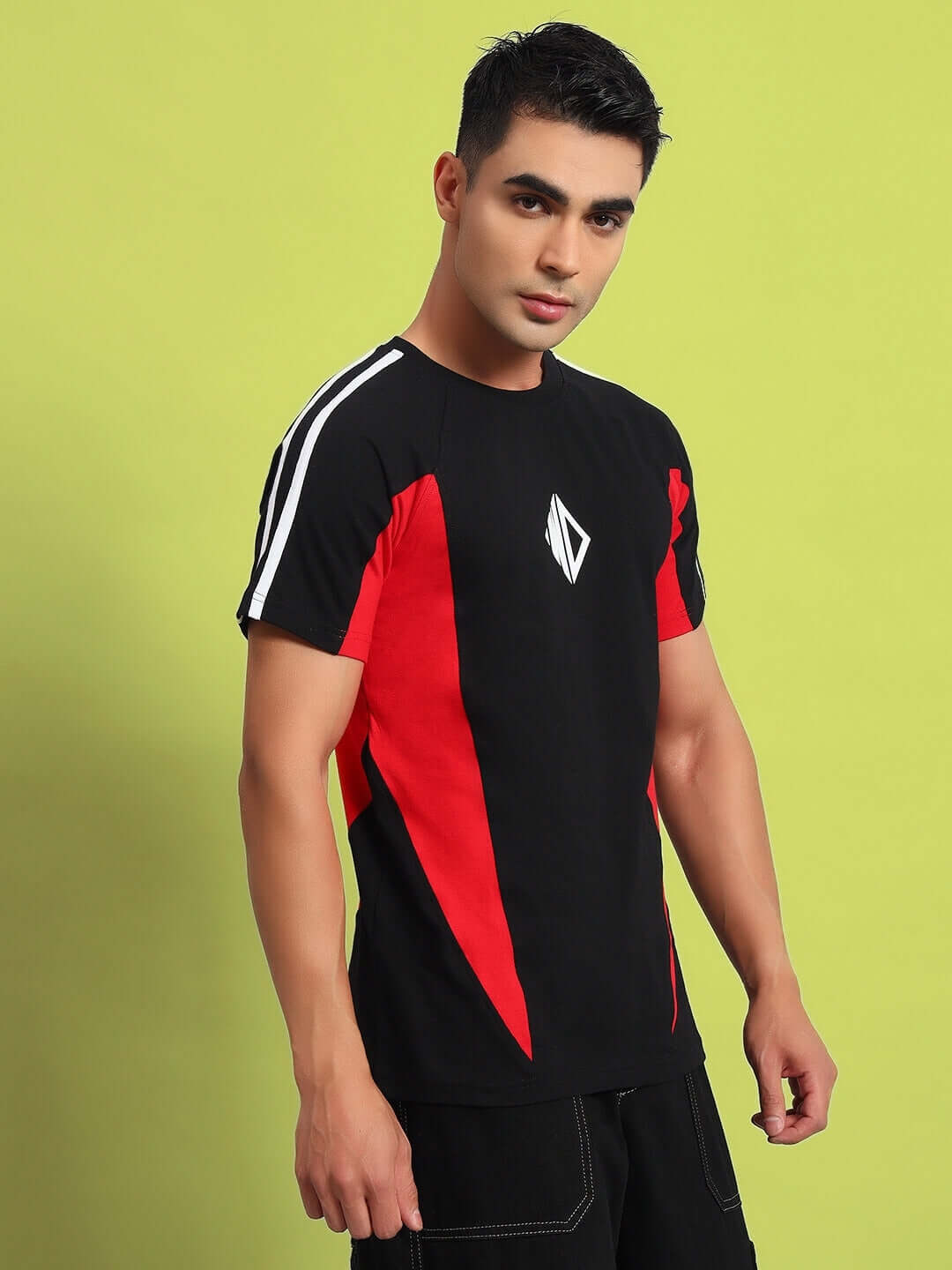 Man wearing a black-red TOPLINER regular t-shirt made of premium cotton, showcasing its stylish design against a light green background.