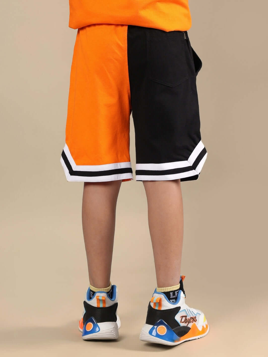 TRACK & FIELD SHORTS FOR BOYS & GIRLS BLACK-ORANGE Track & field shorts for boys & girls in black and orange, made to order by DUDS, shown from the back with contrasting hem design.