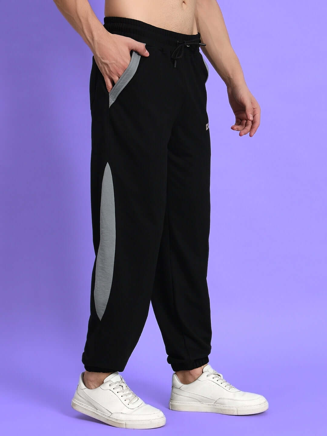 Model wearing Trackpoint Baggy Joggers in black and grey by DUDS, highlighting custom fit options for stylish, comfortable wear.