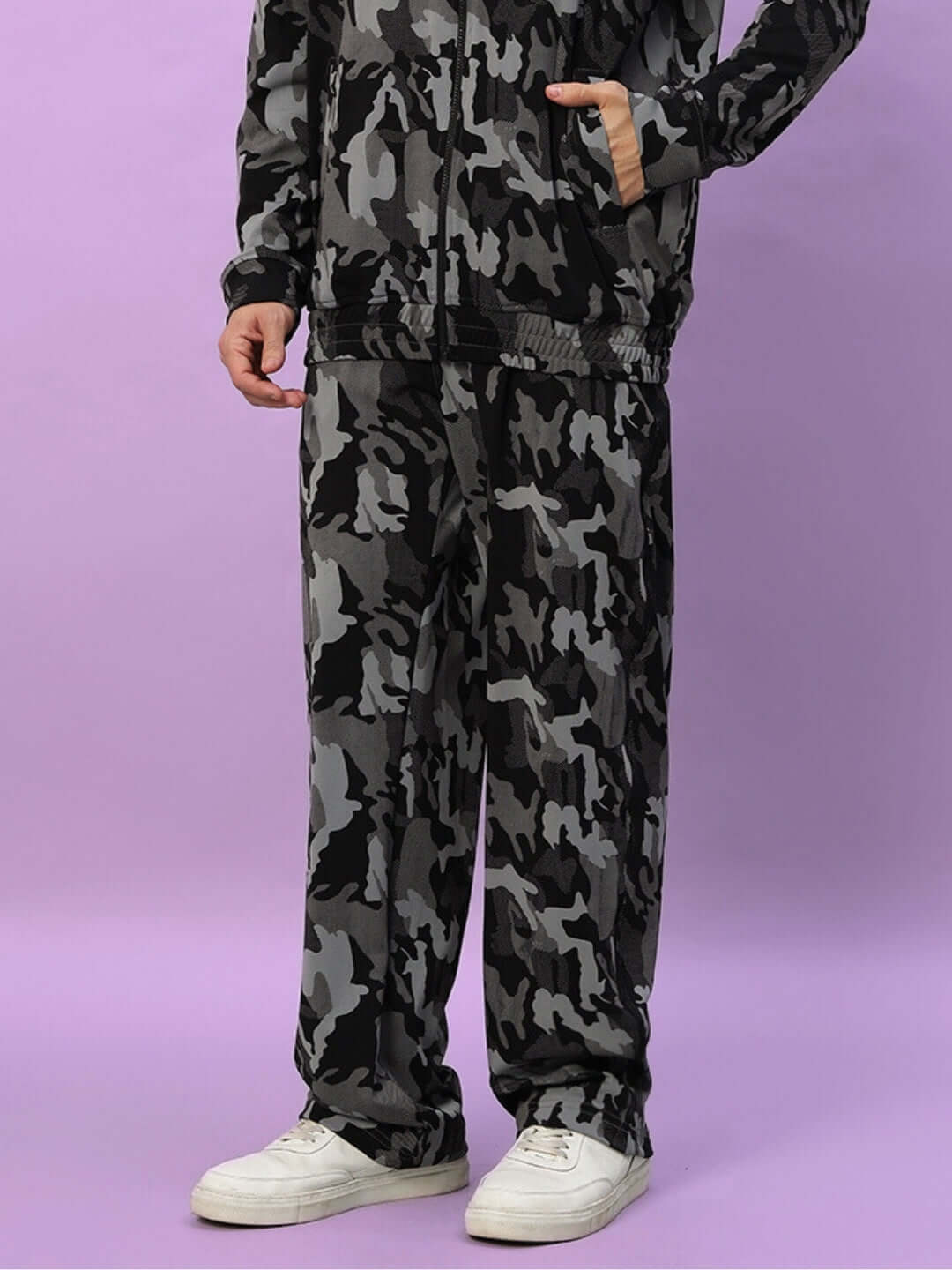Camo navy jogger pants displayed on model with purple background, featuring relaxed fit and tailored design by DUDS.