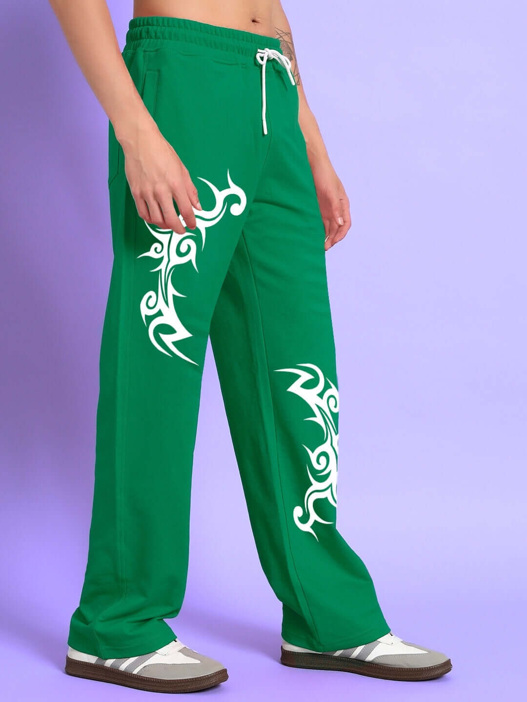 Person wearing TRIBAL STRONG SENSE JOGGER GREEN with tribal patterns, side view.