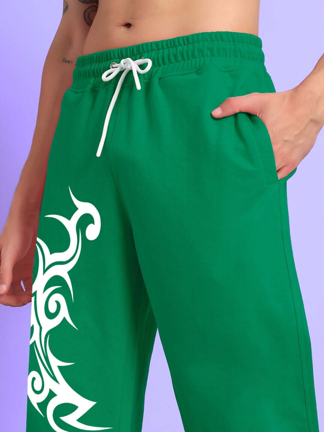 Person wearing TRIBAL STRONG SENSE JOGGER GREEN with tribal design.
