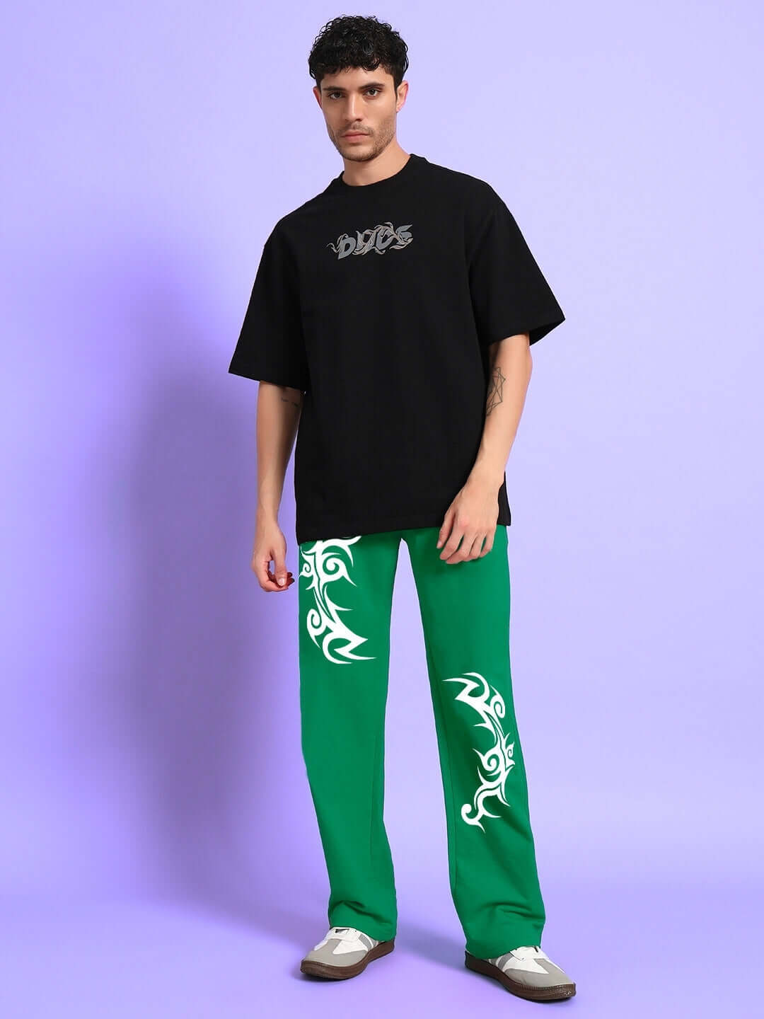 Model wearing Tribal Strong Sense Jogger Green with bold tribal patterns, showcasing modern streetwear style.