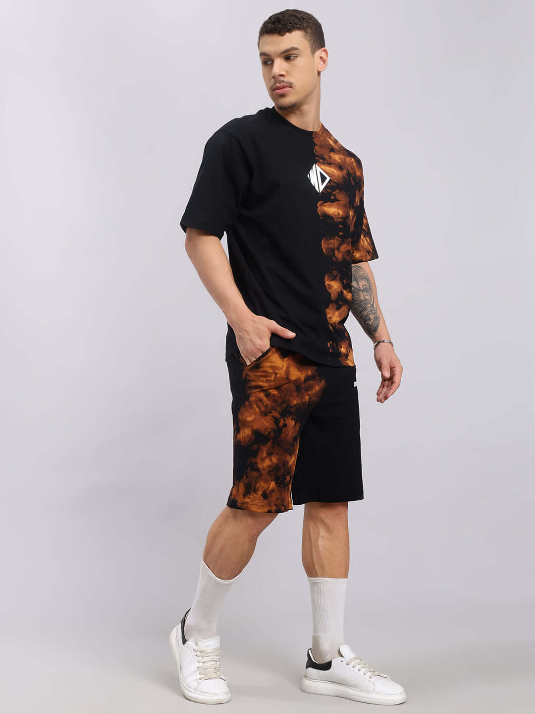 Man wearing Trickster Tie-Dye Co-Ord Set in black with orange tie-dye design, featuring premium cotton and terry fabric. Fashionable and stylish.