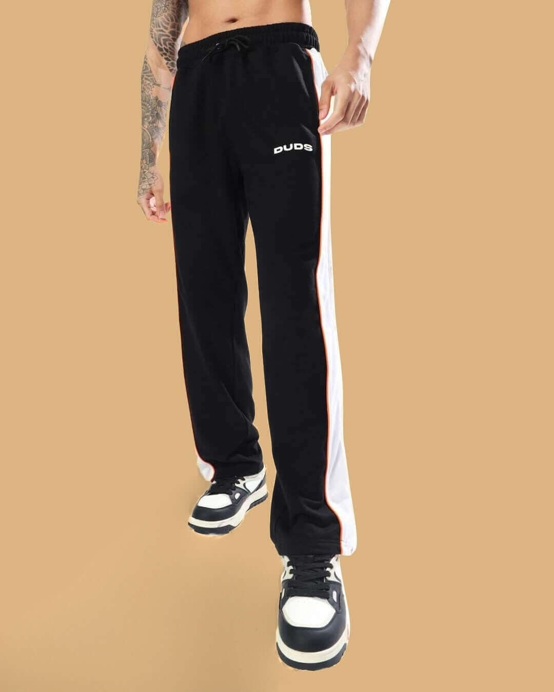 Black and orange TRIUMPH multi zipper joggers by DUDS, featuring a stylish side stripe and comfortable fit.