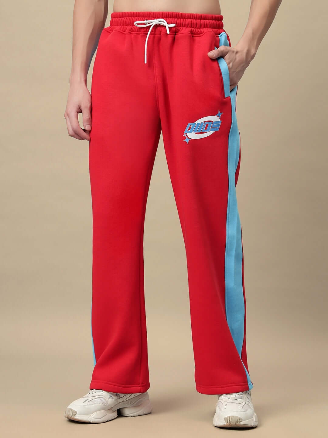 Person wearing Trunkit Fleece Colorblock Cargo Pant in red with blue accents, showcasing streetwear style and comfort.