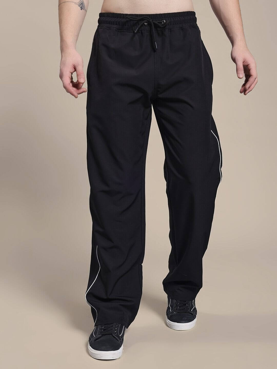 Man wearing TURBO TRACK RELAXED-FIT JOGGERS BLACK showcasing streetwear style.