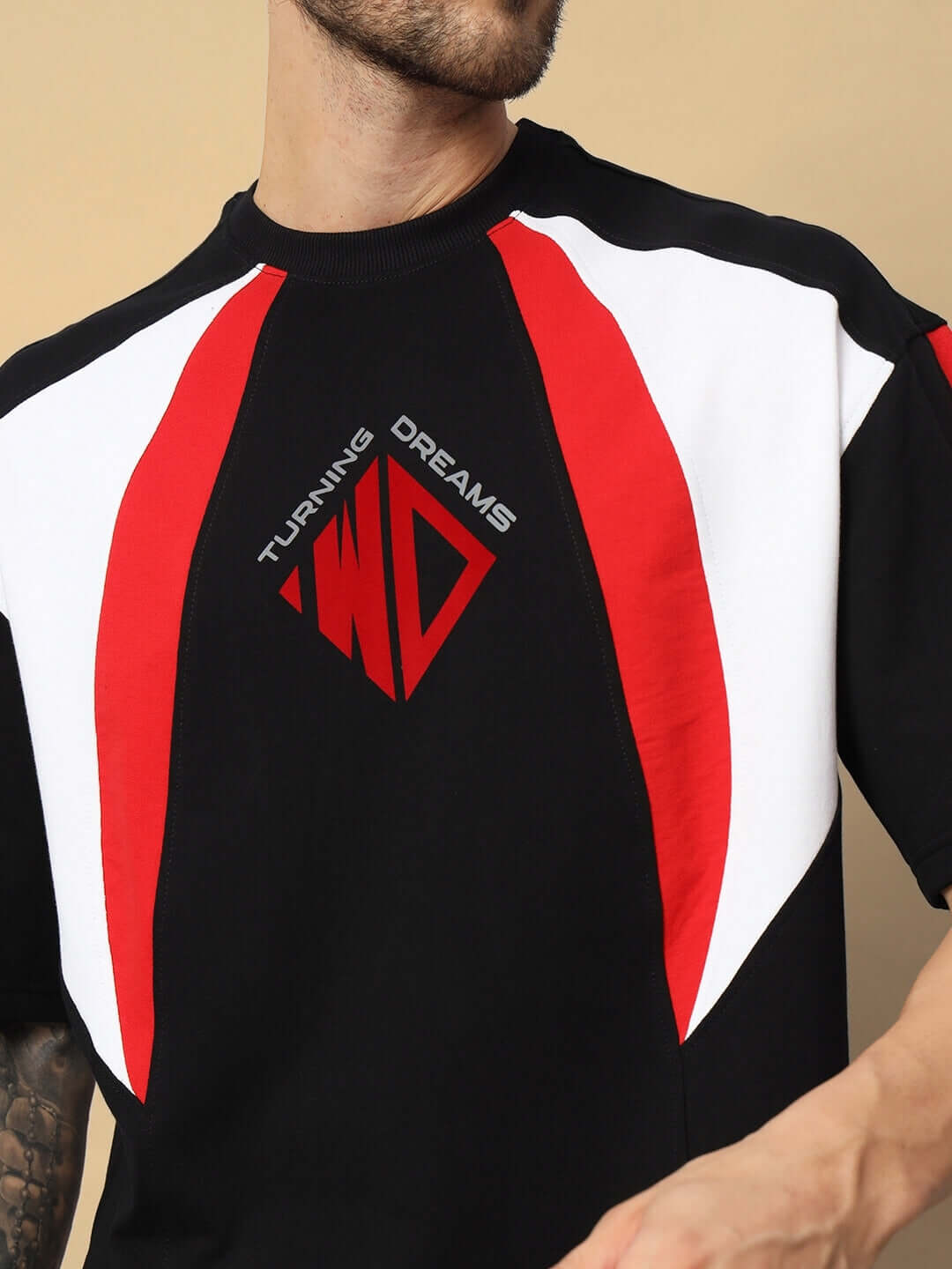 Black oversized T-shirt with red and white accents, Turning Dreams logo, made from premium cotton French terry blend.