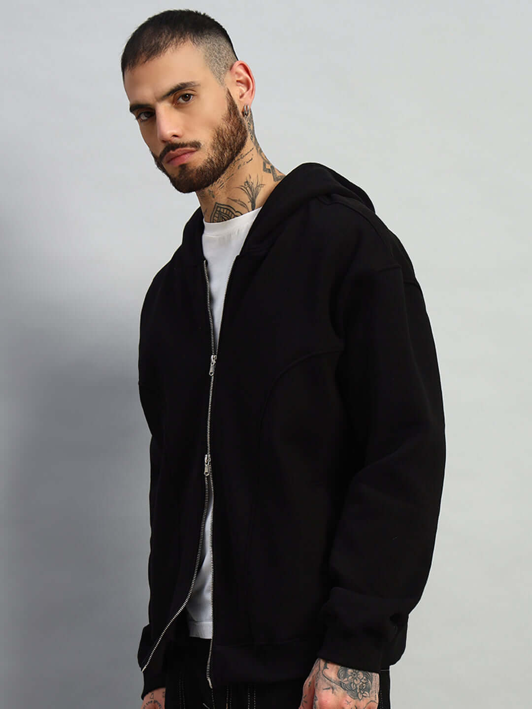 Model wearing WEARDUDS TWO FOLD ZIPPER HOODIE BLACK, showcasing modern design and comfort.