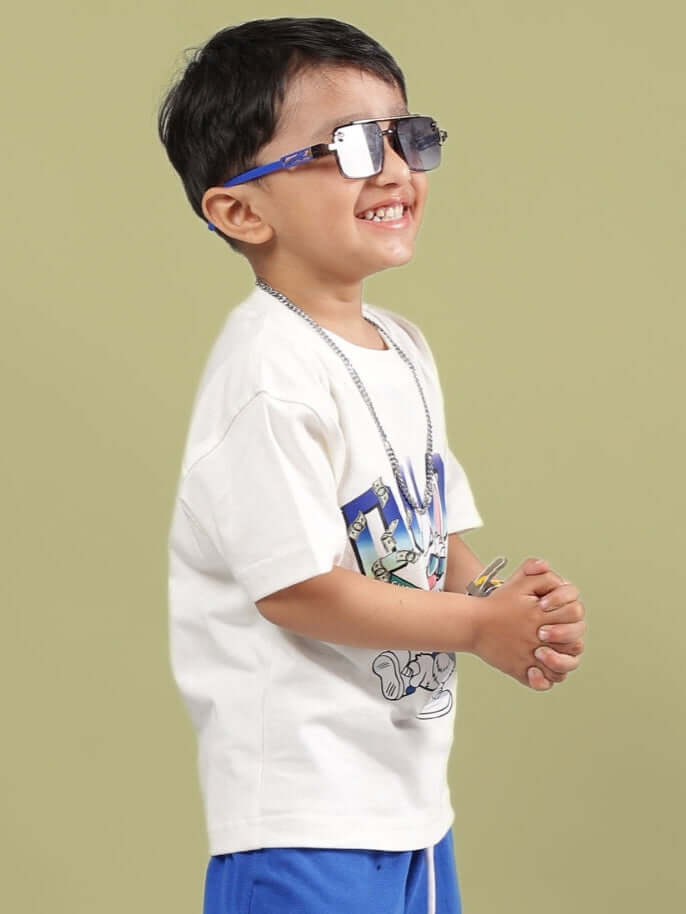 Child wearing BUMBLE T-SHIRT FOR BOYS GIRLS OFF WHITE with sunglasses, showcasing style and comfort. Perfect unisex tee for kids.