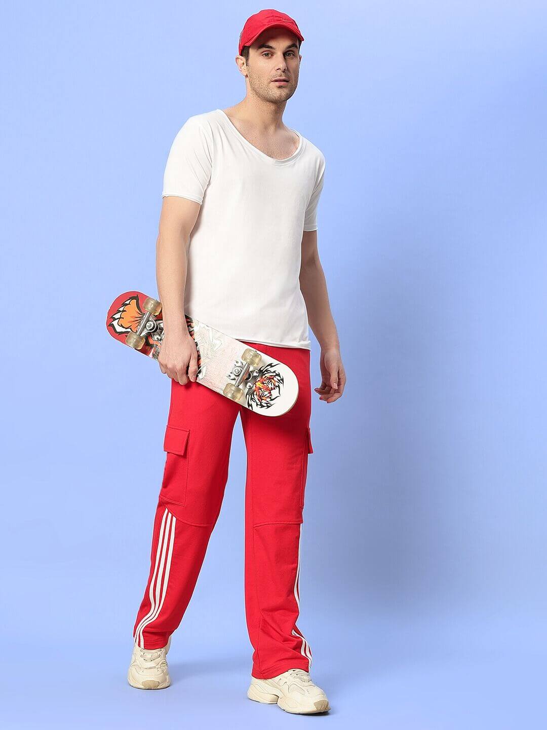 Unisex relaxed fit joggers with red and white contrast panel, featuring elastic waistband and drawstring, made from premium cotton blend.