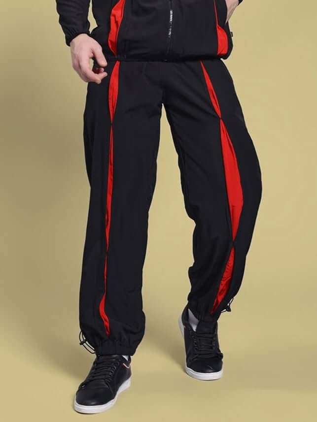 Model wearing UNISON RELAXED-FIT JOGGERS BLACK RED showing front view with stylish design for kids' activewear.