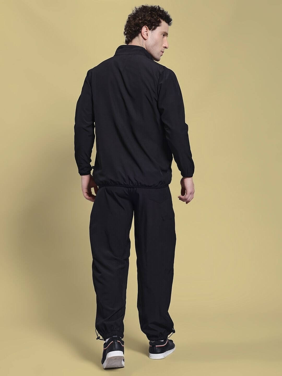 Man wearing the UNISON RELAXED FIT CO-ORD SET BLACK RED from the back view