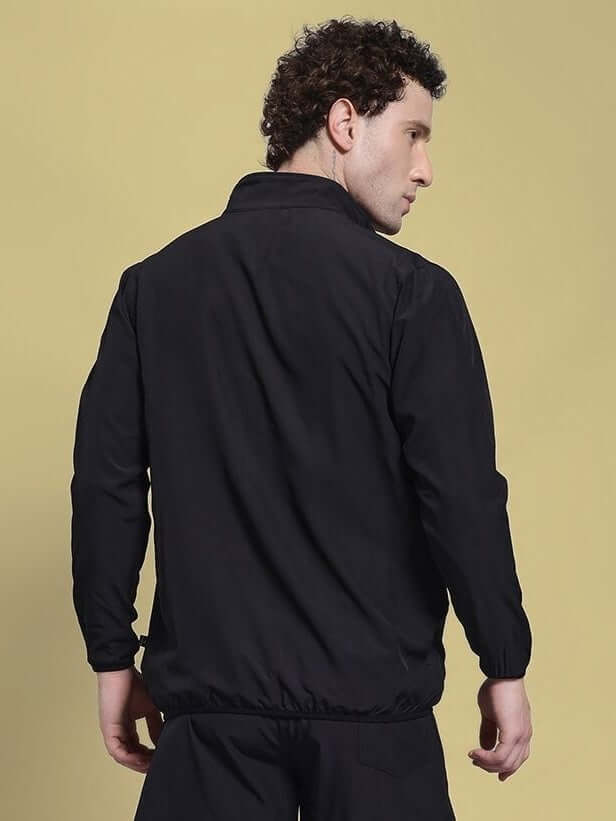 Man wearing UNISON RELAXED FIT JACKET BLACK RED showing back view