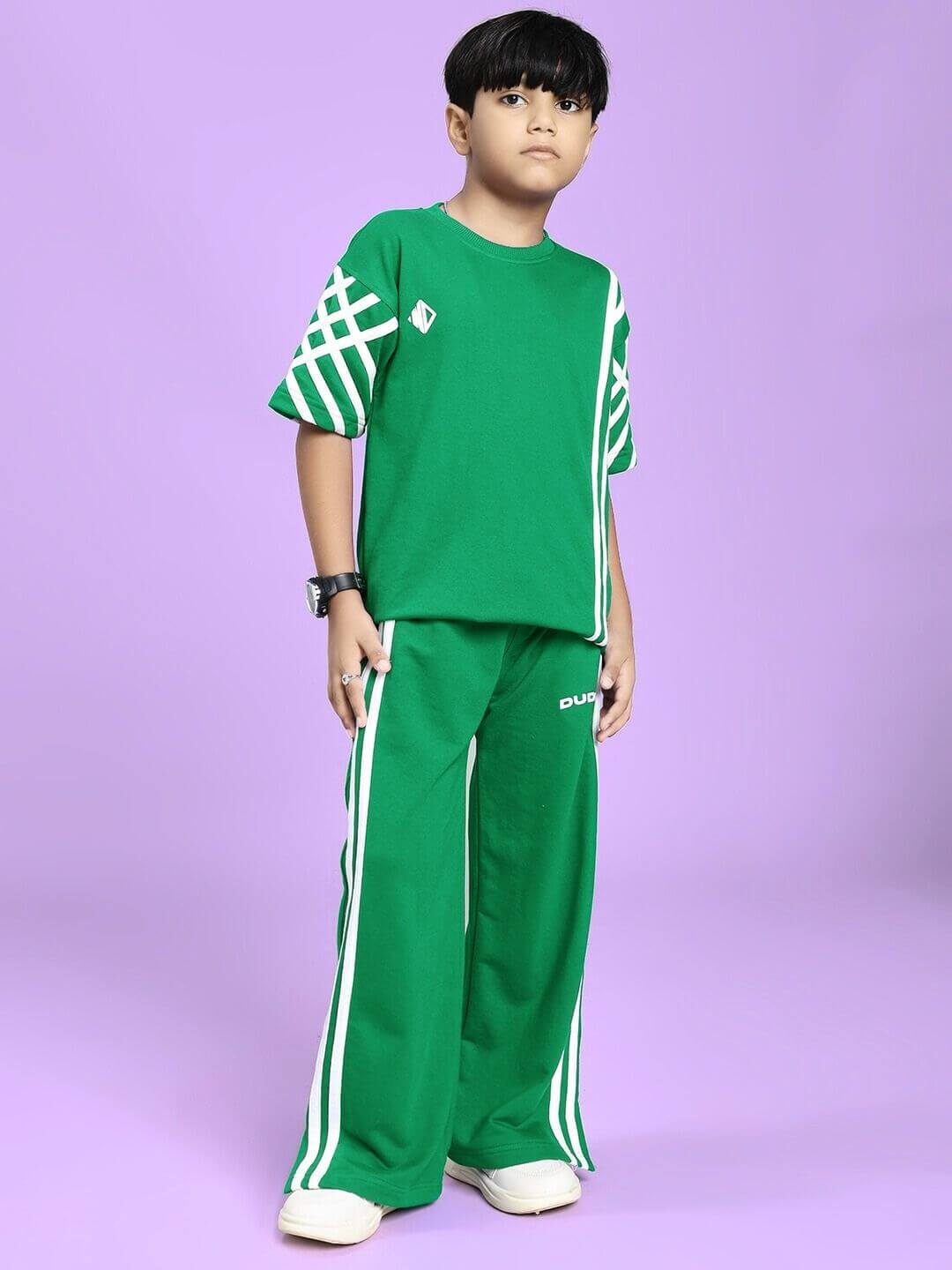 Child wearing UNITED STRIPE CO-ORD SET FOR BOYS GIRLS GREEN, showcasing breathable fabric with modern stripe design on a purple background.