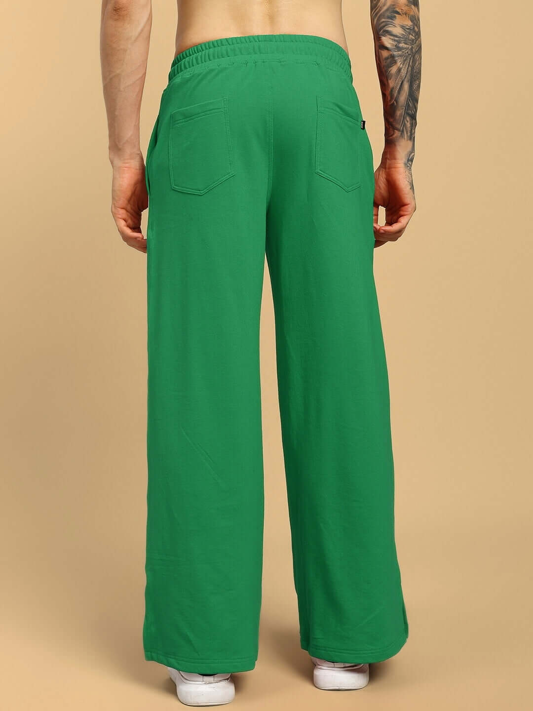 Back view of UNITED STRIPE CO-ORD SET GREEN pants with stripe detailing, displaying streetwear fashion and comfort.