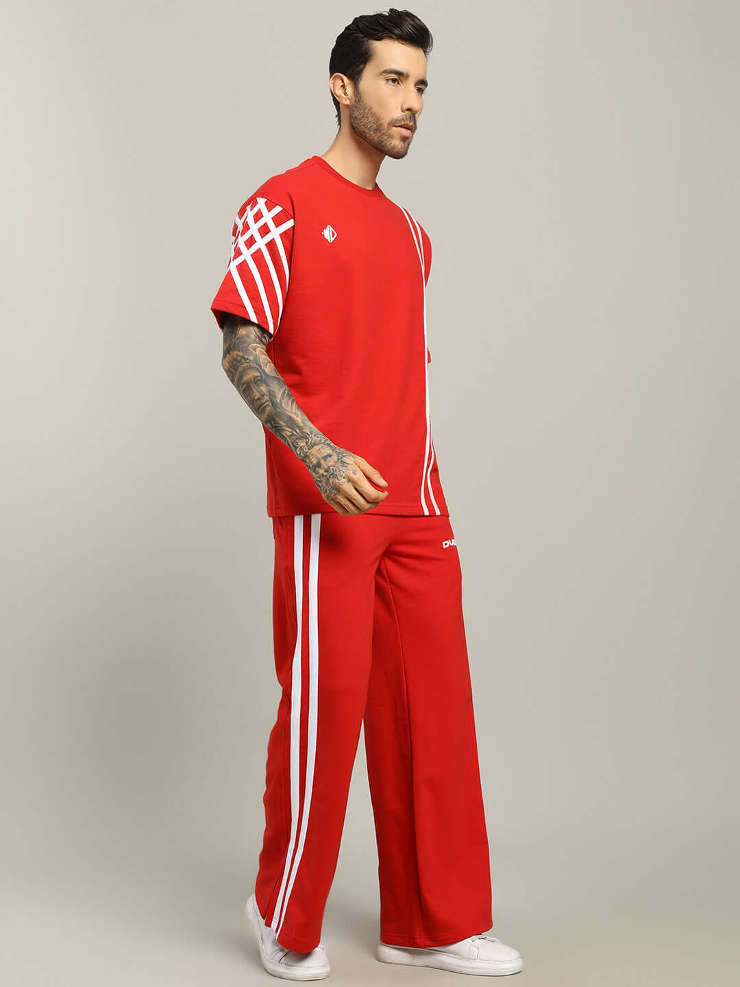 Model wearing red United Stripe Co-ord Set with white stripes, crafted from premium cotton French terry lycra. Cold machine wash.