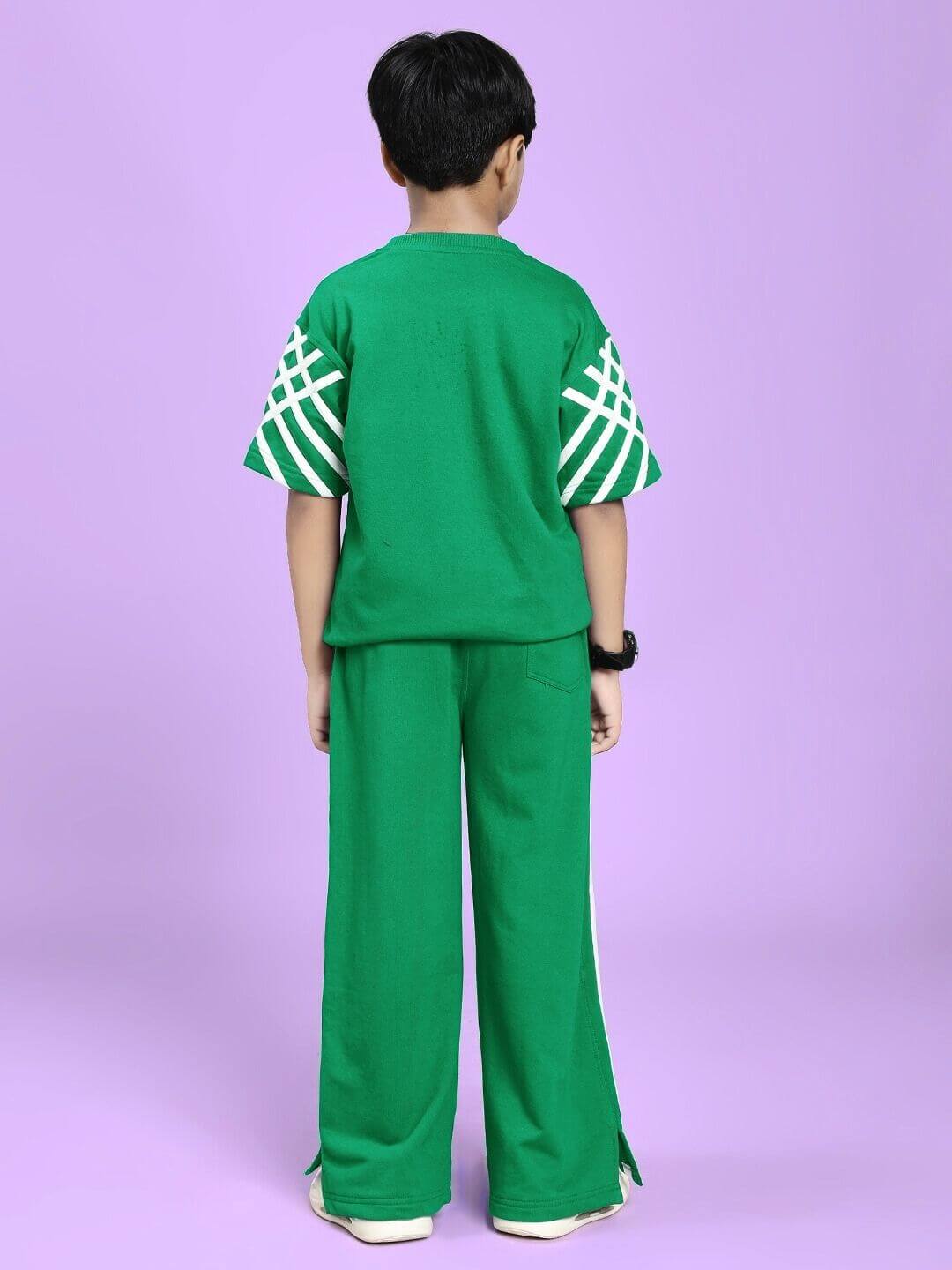 Kid wearing UNITED STRIPE CO-ORD SET FOR BOYS GIRLS GREEN with modern stripes, showing back view on purple background.