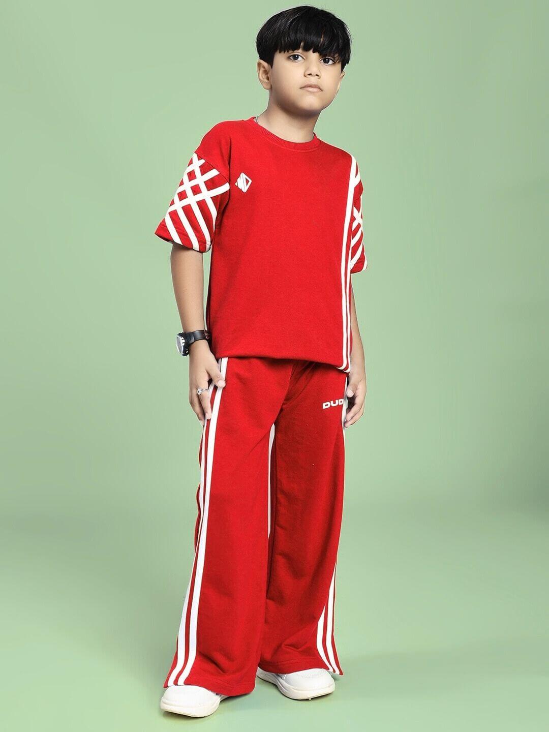 Child wearing UNITED STRIPE CO-ORD SET FOR BOYS GIRLS RED, featuring vibrant red color and sporty stripe accents, posing confidently.