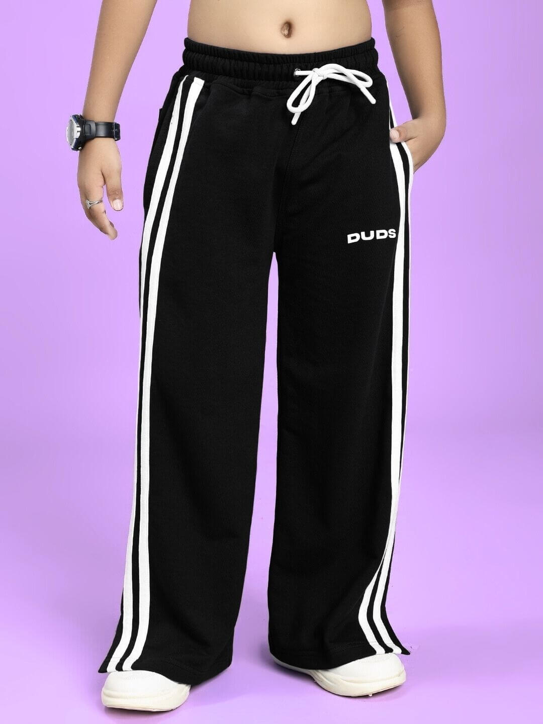 UNITED STRIPE JOGGER FOR BOYS AND GIRLS BLACK with drawstring and side stripes displayed on a purple background