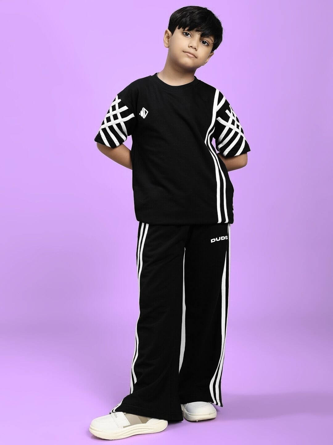 UNITED STRIPE JOGGER FOR BOYS AND GIRLS BLACK with stylish white stripe detail, perfect for active kids in a modern casual outfit.
