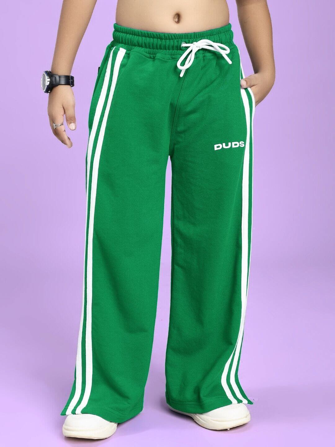 Child wearing UNITED STRIPE JOGGER FOR BOYS AND GIRLS GREEN with white stripes.