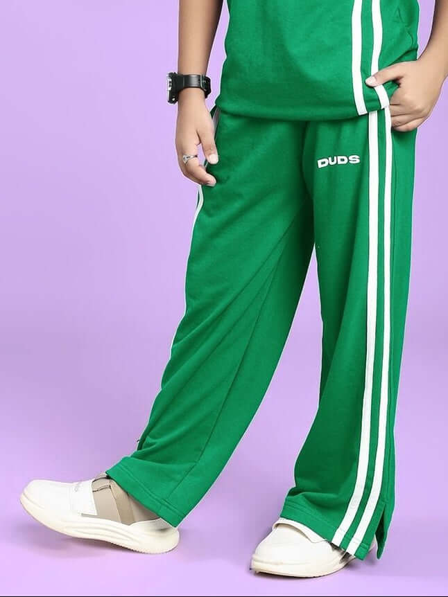 Child wearing UNITED STRIPE JOGGER FOR BOYS AND GIRLS GREEN with white stripes, showcasing stylish and comfortable kids' activewear.