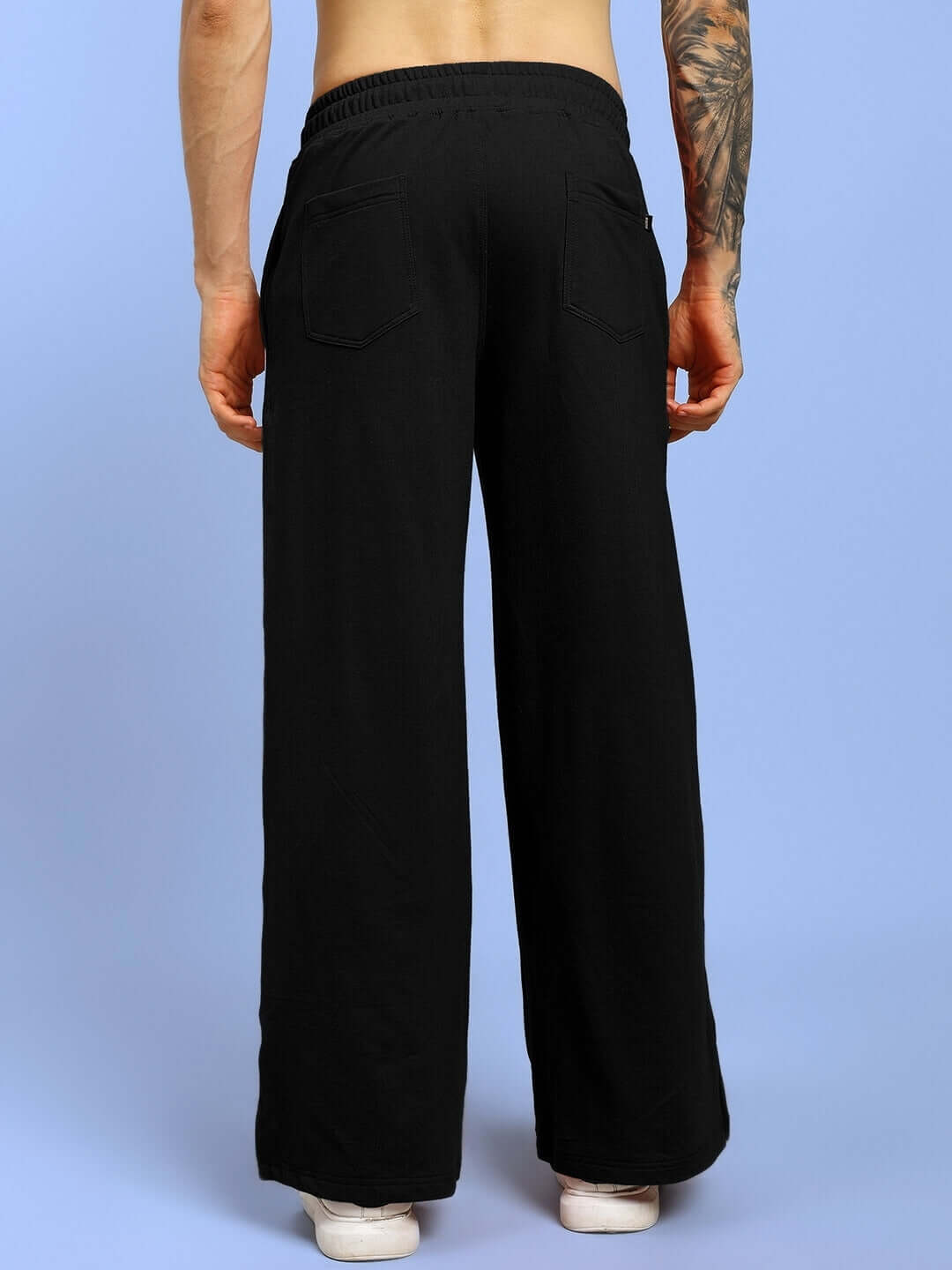 Model wearing black United Stripe Joggers, showcasing custom fit options by DUDS, made by experienced tailors.