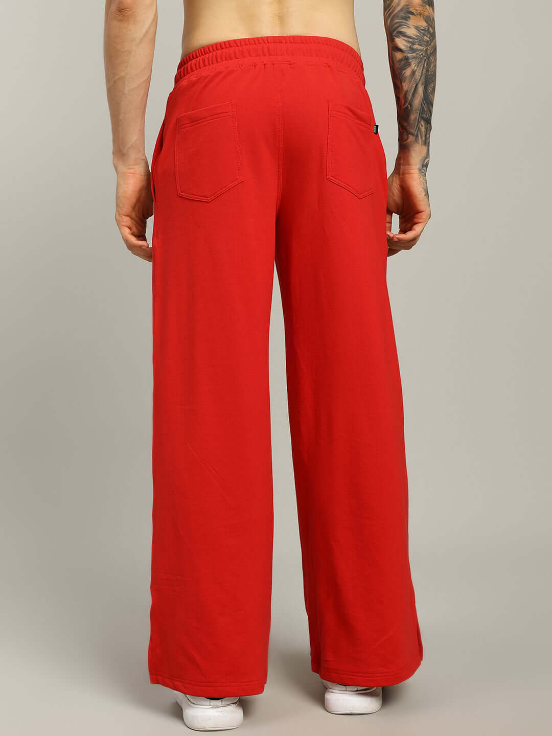 Back view of UNITED STRIPE JOGGERS MEN - RED showcasing bold streetwear style with red base and stripe detailing for versatile looks.