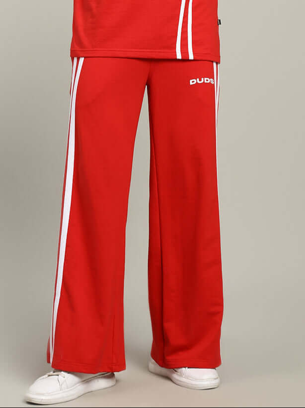 Model wearing UNITED STRIPE JOGGERS MEN - RED with white stripes, perfect for streetwear and athleisure style.