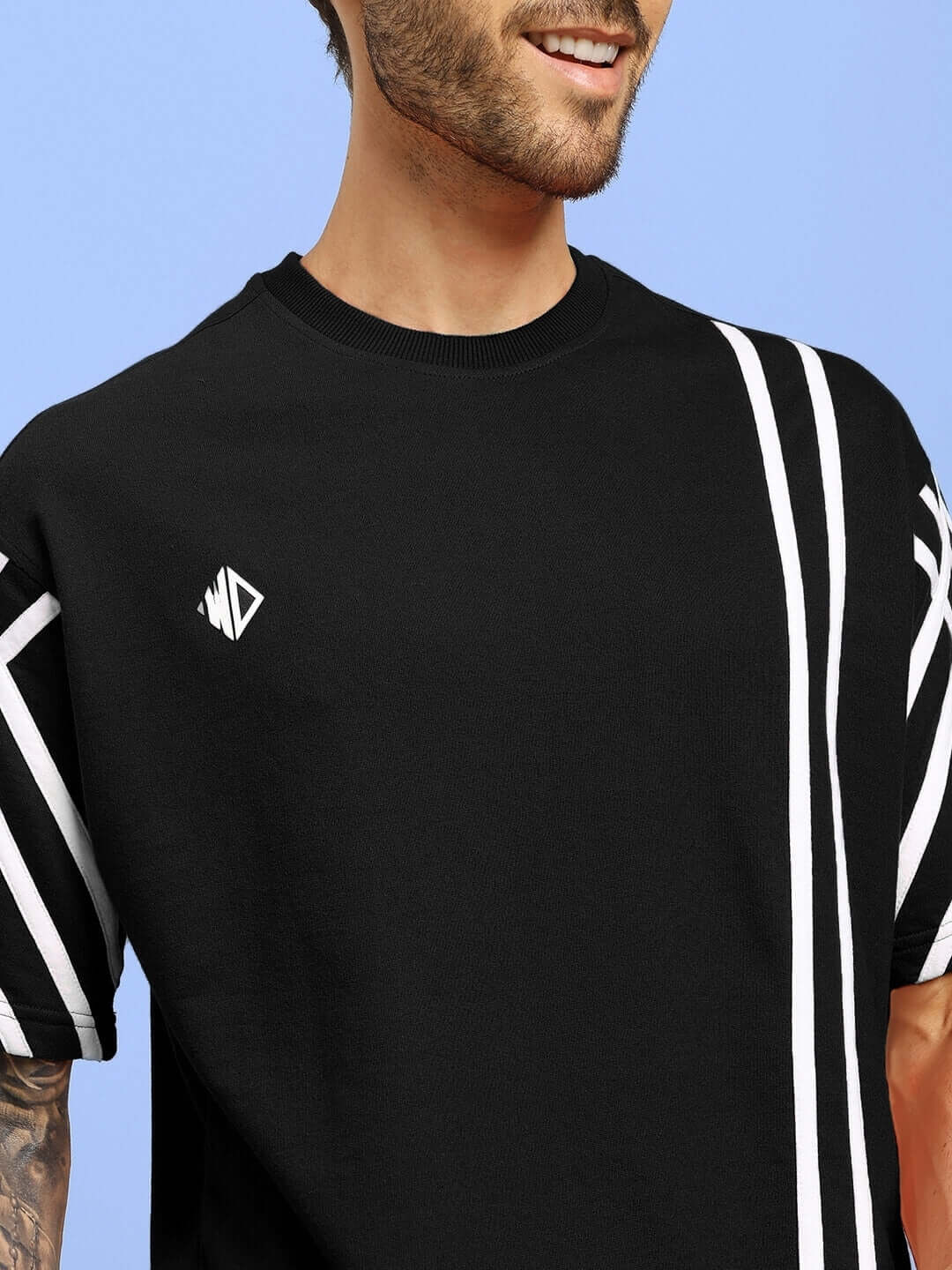 Black oversized t-shirt with white stripes, made from premium heavy gauge fabric, worn by male model, by Color By Colours.