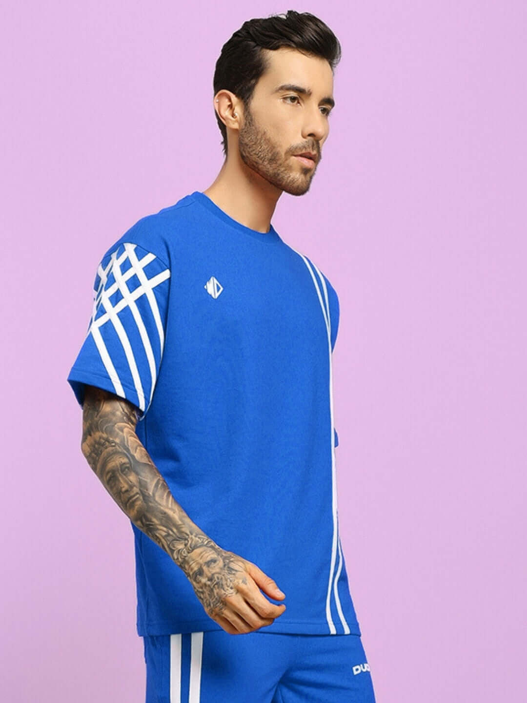 Model wearing a blue UNITED STRIPE oversized t-shirt made from premium cotton fabric by Color By Colours