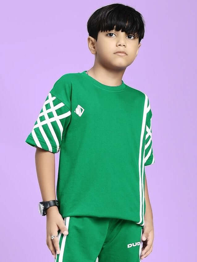 UNITED STRIPE T-SHIRT FOR BOYS AND GIRLS GREEN with white stripes, worn by a child, on a purple background.