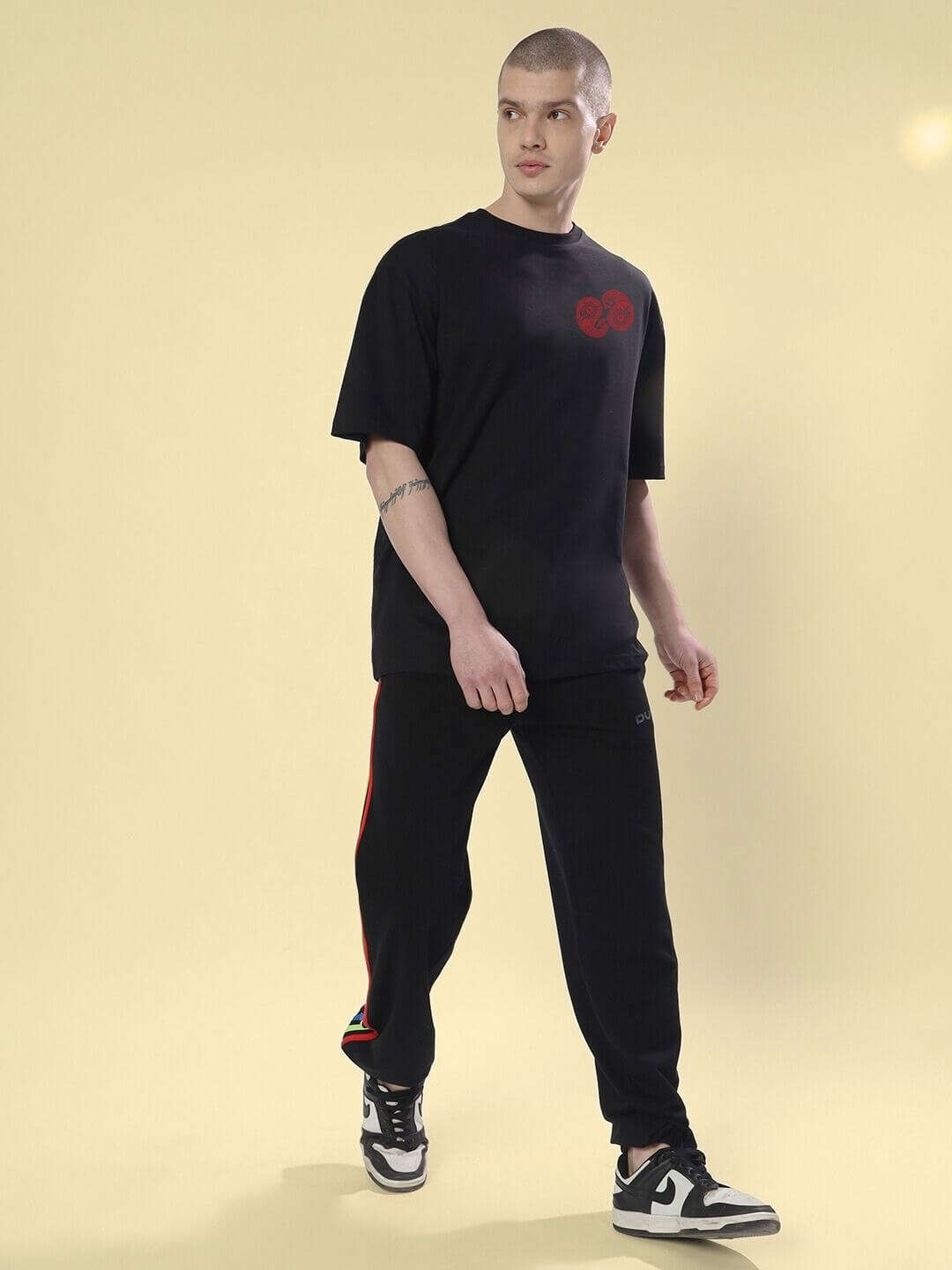 Model wearing URBAN CULTURE PRINTED OVERSIZED T-SHIRT BLACK showcasing urban street style.