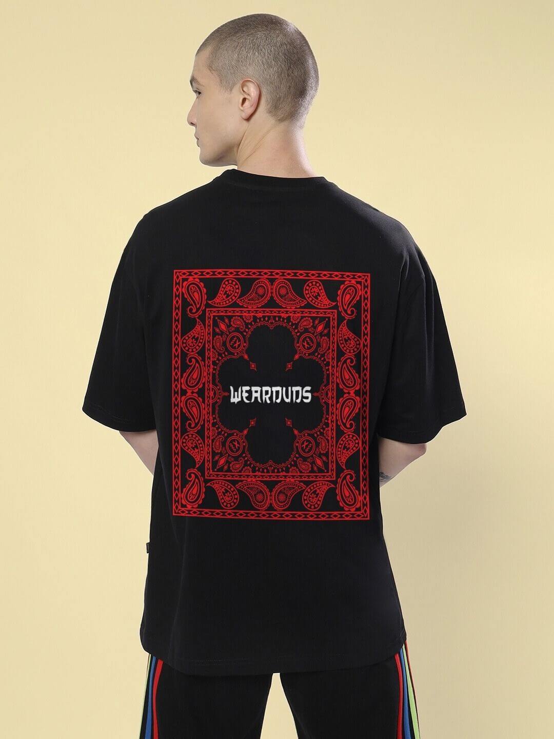 Back view of Urban Culture Printed Oversized T-Shirt Black with red urban-inspired graphics, worn by a person, showcasing street-smart style.