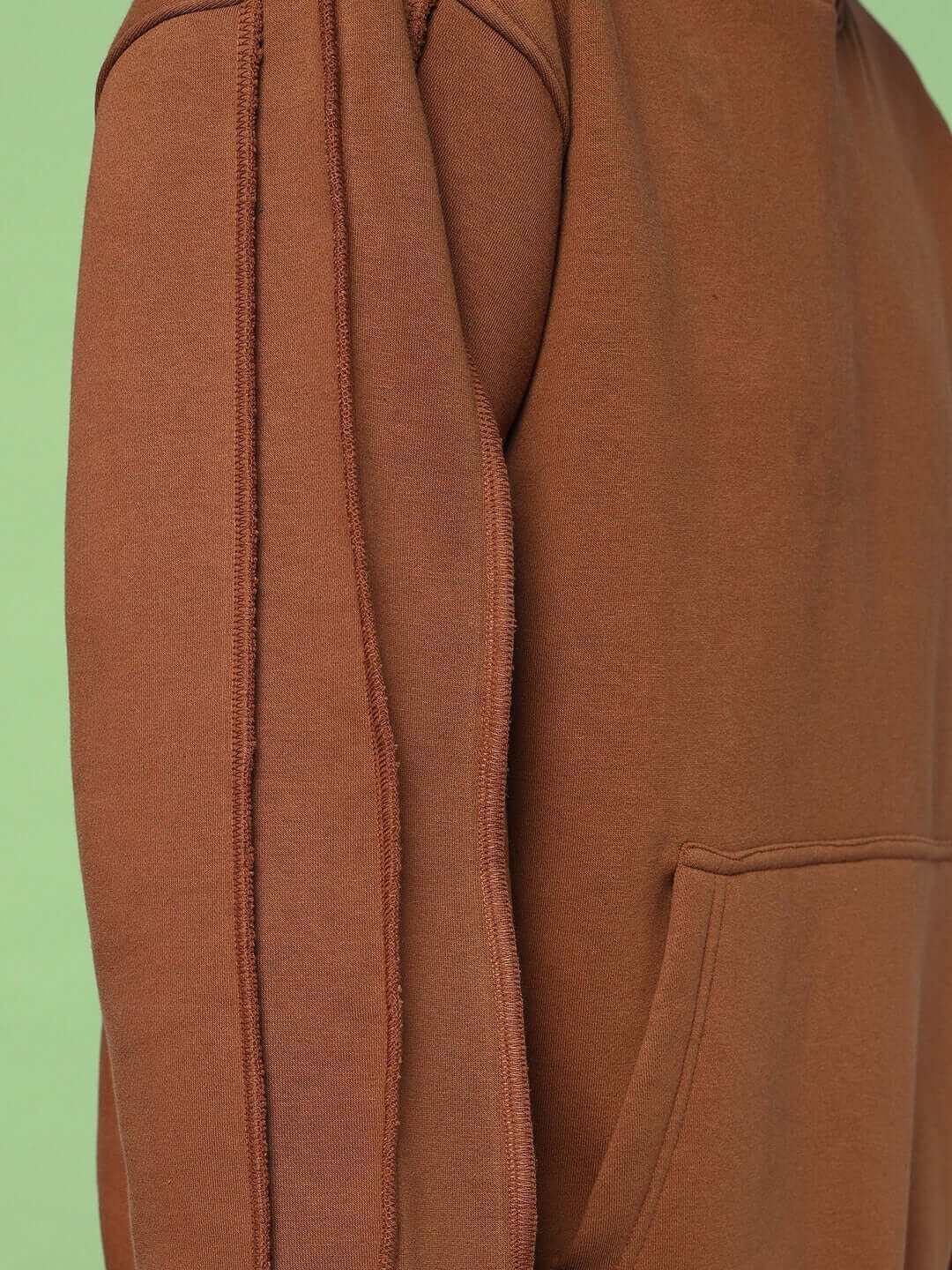 Close-up of sleeve and pocket detail on URBAN SOLID PLATED FLEECE HOODIE BROWN, showcasing high-quality fleece material and design.