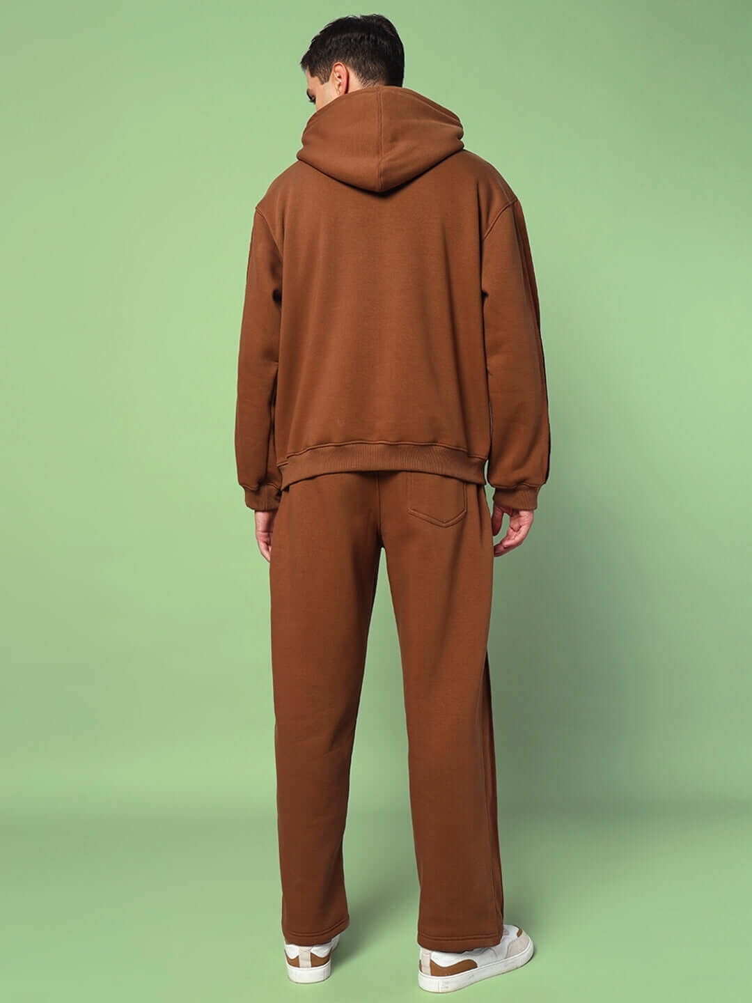 Man wearing URBAN SOLID PLATED FLEECE CO-ORD BROWN set with hoodie and joggers, facing backwards.