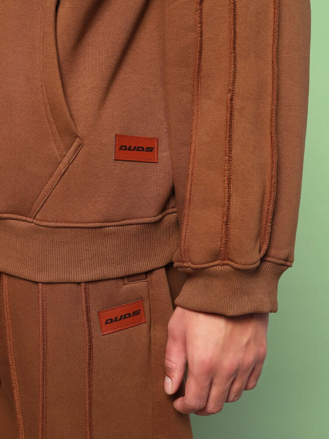 URBAN SOLID PLATED FLEECE CO-ORD BROWN outfit showcasing hoodie and joggers with ribbed details and a kangaroo pocket.
