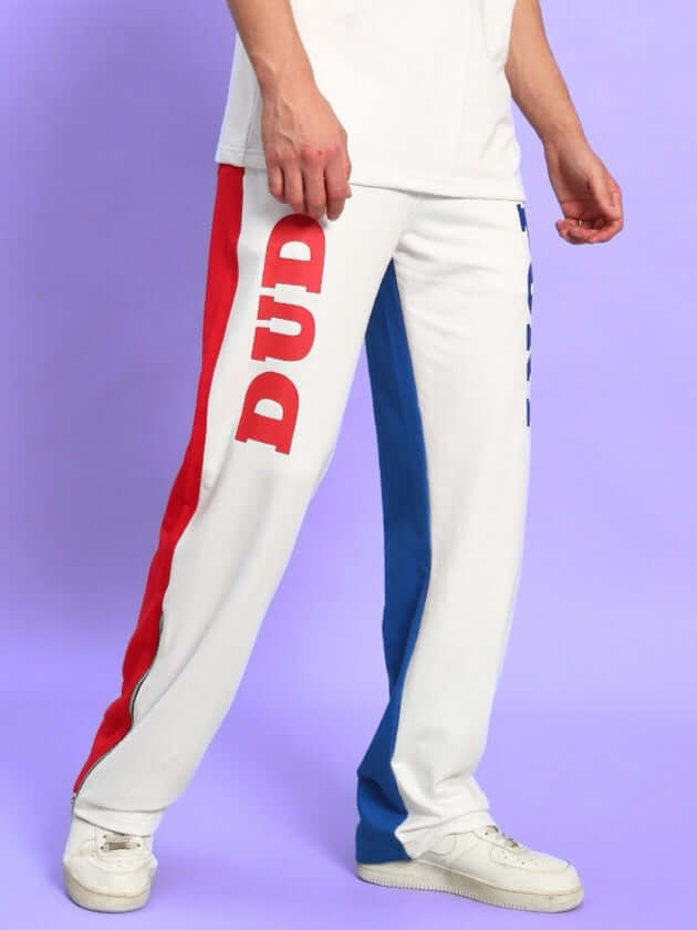 Person wearing URBAN DRIFT Relaxed Fit Joggers in white multi-color with bold red and blue stripes, by DUDS.