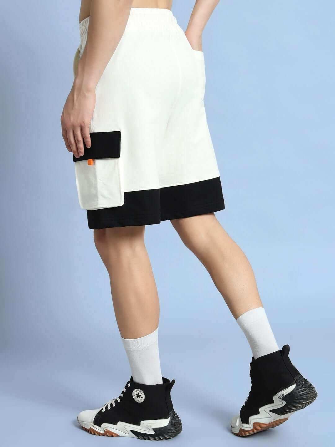 Off white-black utility cargo shorts with side pocket, worn by a model. Ideal for custom fit orders from DUDS. Stylish and comfortable.