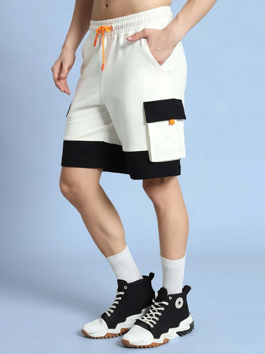 Model wearing off white-black utility cargo shorts, showcasing side pockets and drawstring design.