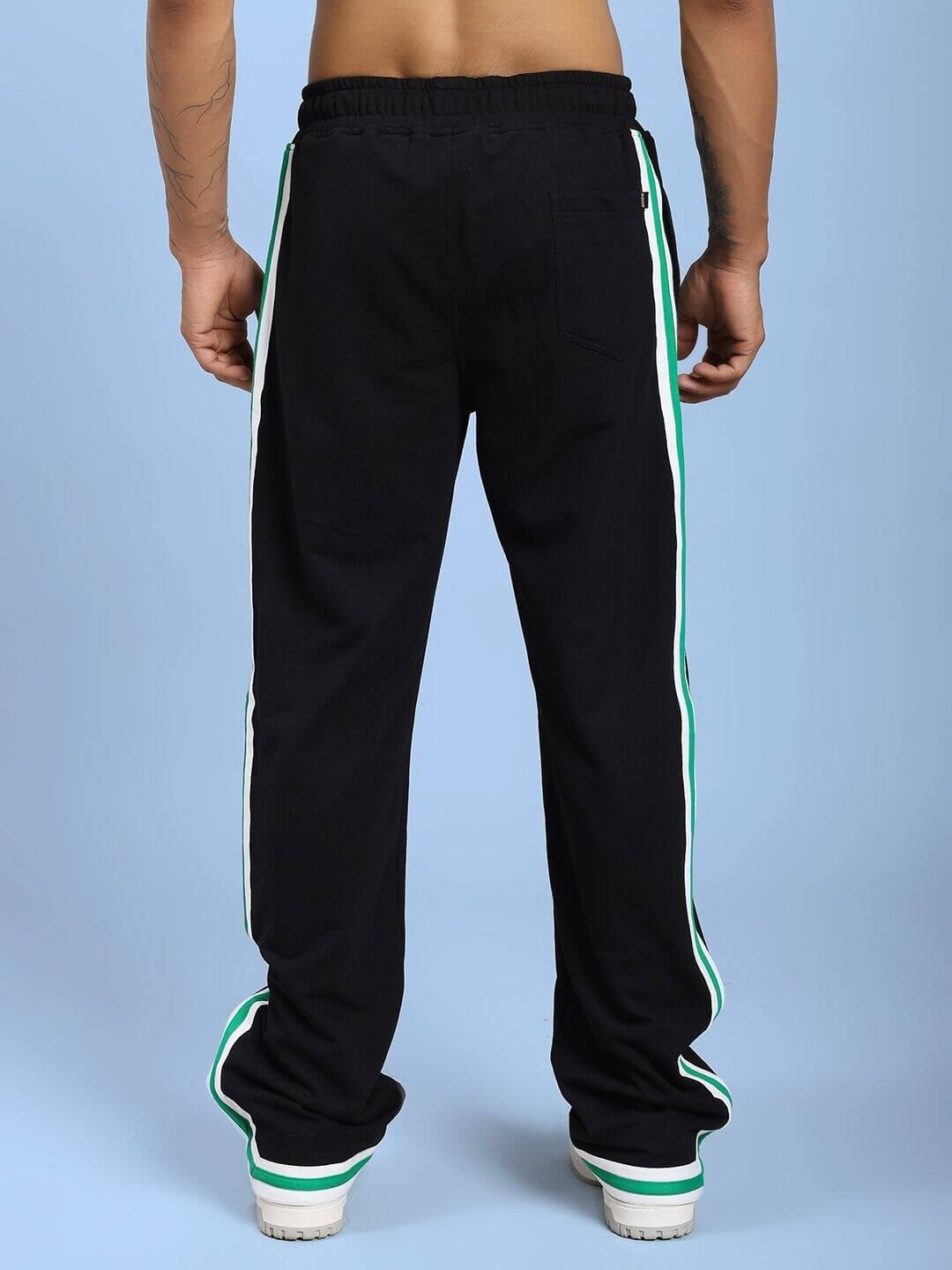 Back view of VELO GREEN STRIPE RELAXED FIT JOGGER BLACK featuring green stripe on sides, showcasing relaxed fit and stretch cotton fabric.