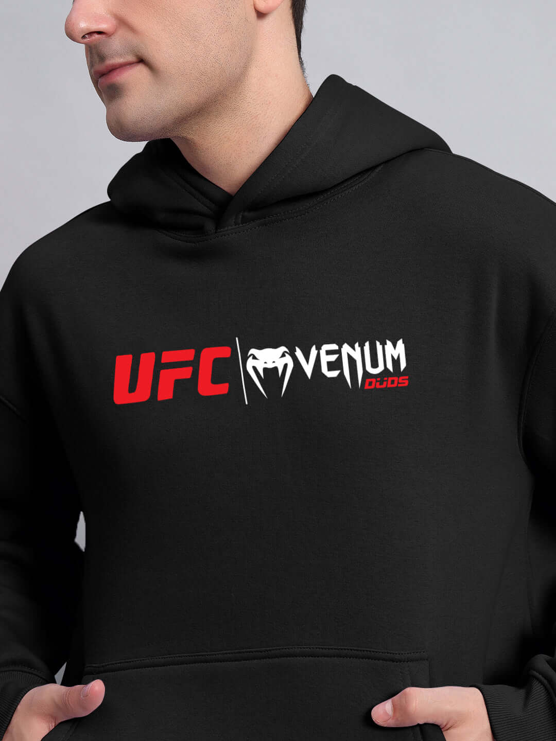 Alt Tag: WEARDUDS VENUM FLEECE HOODIE BLACK worn by model showcasing UFC and Venum branding, made to order with custom fit option available.