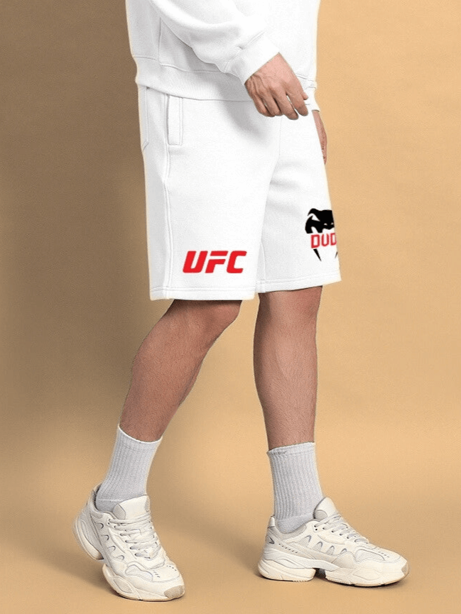 Model wearing WEARDUDS VENUM FLEECE SHORTS WHITE with UFC logo, showcasing sporty casual style.
