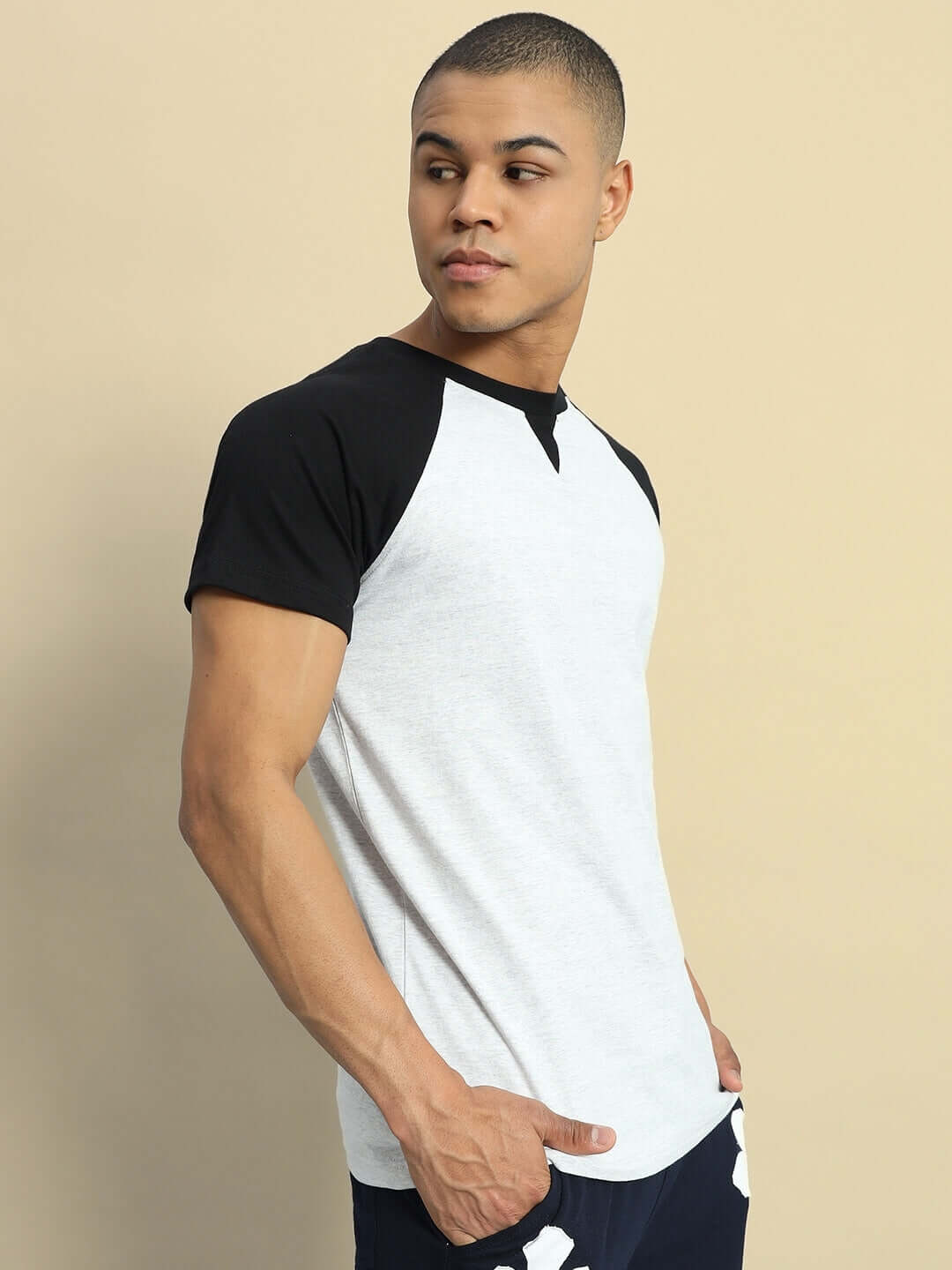 Model wearing VERPA grey melange T-shirt with black sleeves, made of 100% cotton, showcasing a regular fit and premium fabric.