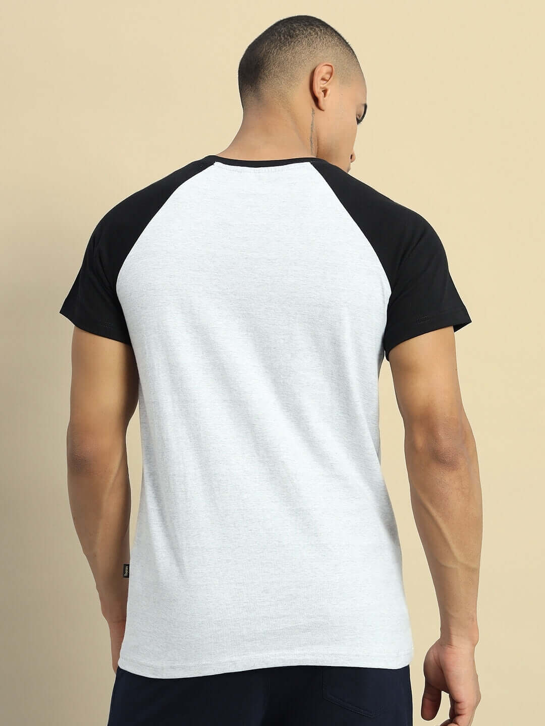 Back view of model wearing Verpa Regular Fit Grey Melange T-shirt, featuring black sleeves and premium 100% cotton fabric.